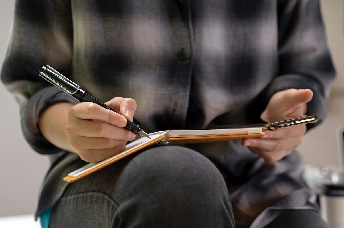 a therapist making notes to document interactive complexity after a therapy session