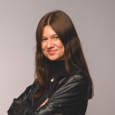 A headshot photo of Alma author Tiphanie Marbach posing in a black jacket and turtleneck.