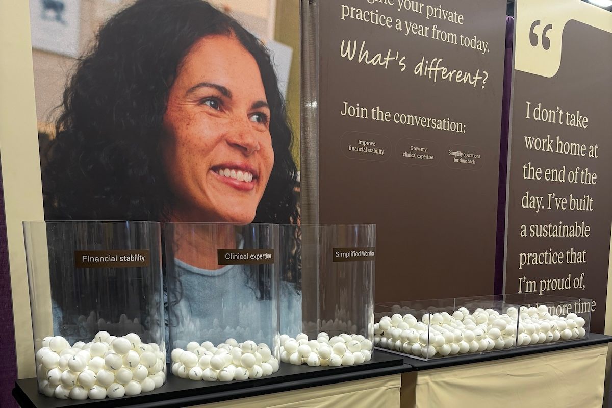 Three giant glass jars full of ping pongs at Alma's ACA conference booth