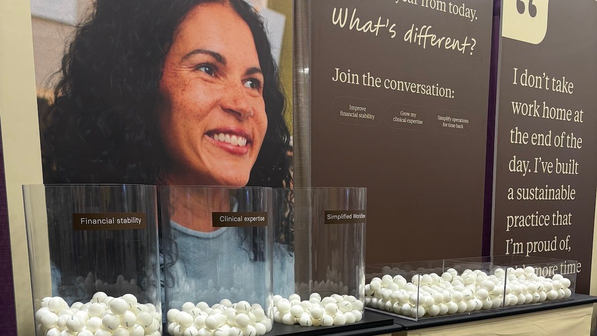 Three giant glass jars full of ping pongs at Alma's ACA conference booth