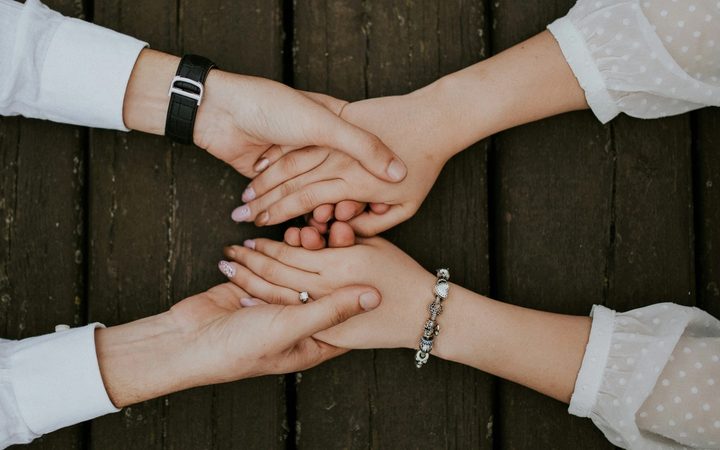 Man and woman holding hands together