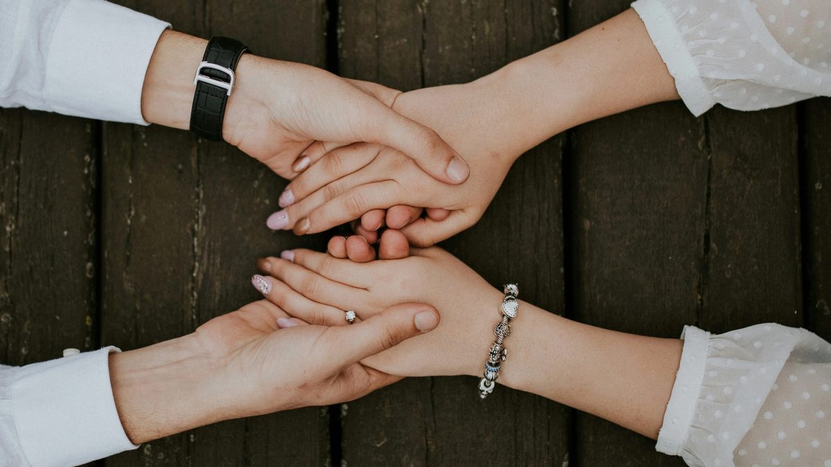 Man and woman holding hands together