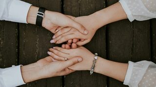 Man and woman holding hands together