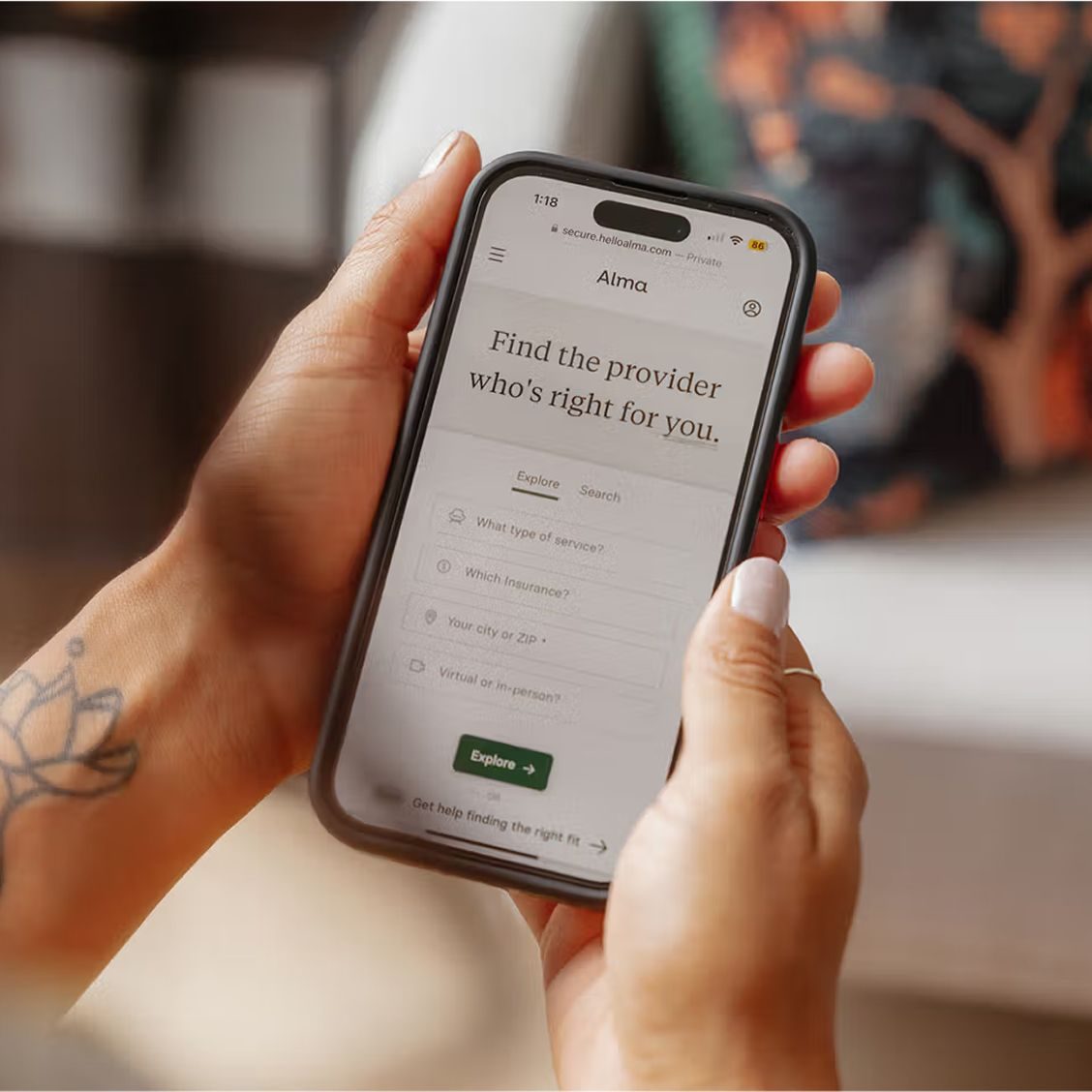 A person using their phone to search for an Alma therapist