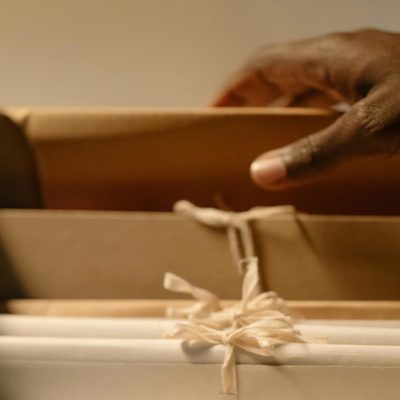 a hand lifting a file folder out of a drawer