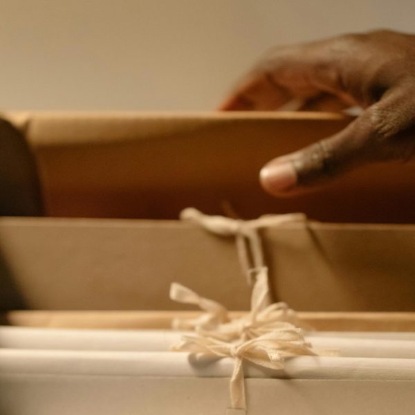 a hand lifting a file folder out of a drawer