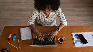 Woman working on her laptop in her office