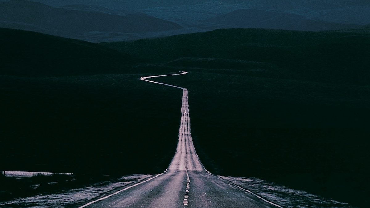 A highway stretching into the distance with a sharp curve visible on the horizon to represent anticipatory anxiety