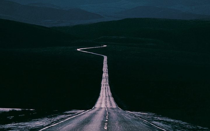 A highway stretching into the distance with a sharp curve visible on the horizon to represent anticipatory anxiety