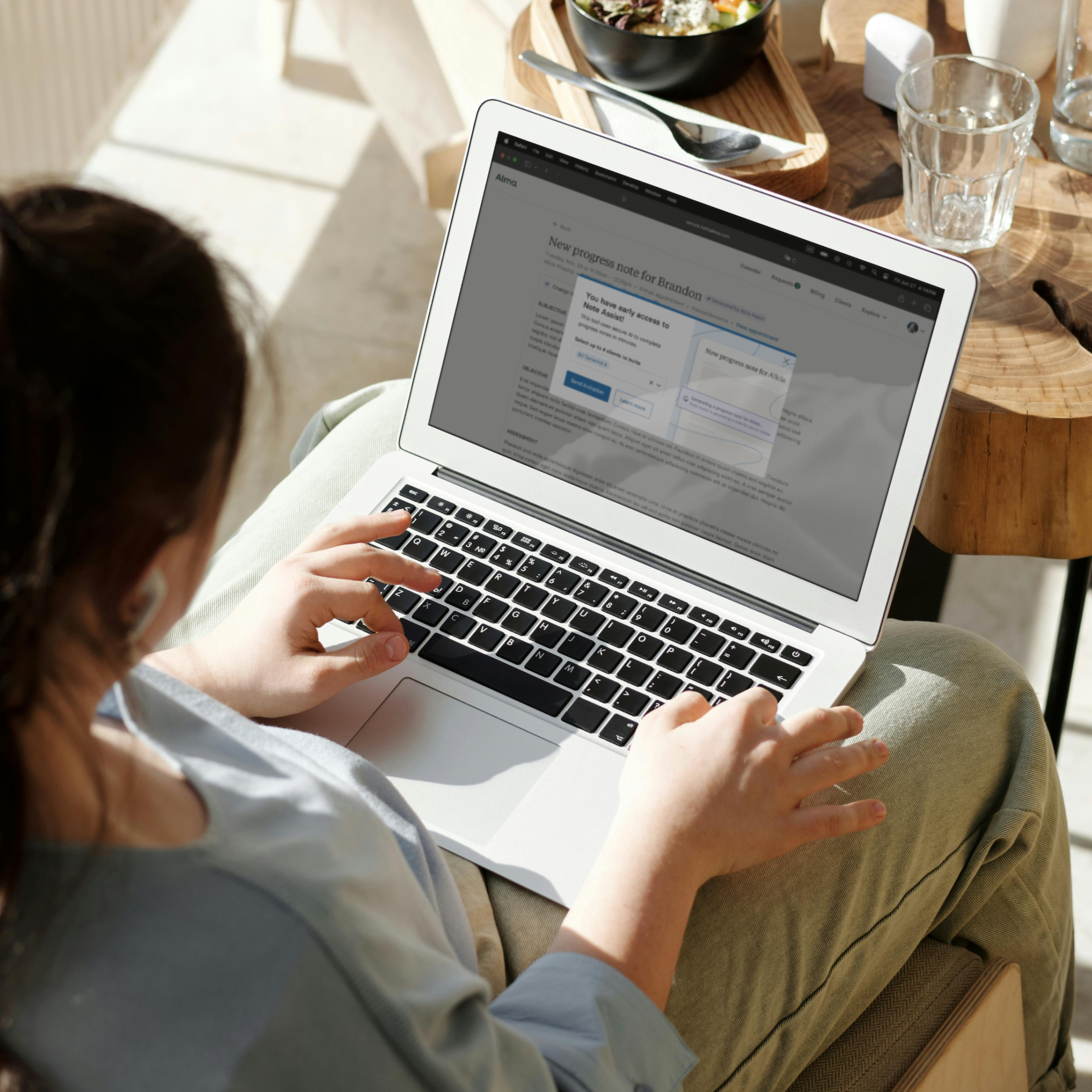 Therapy provider using AI tools on a laptop