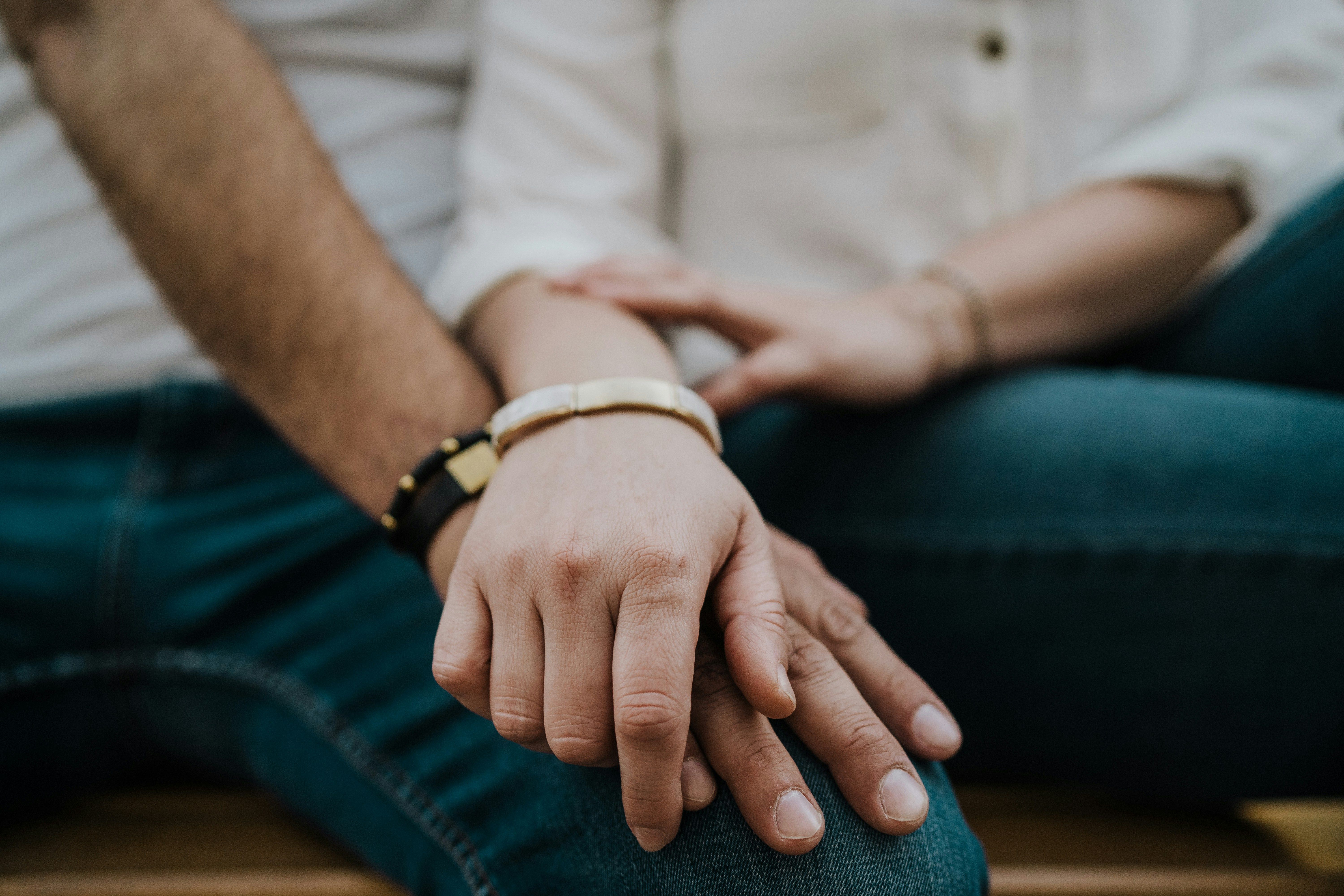 A close-up of a couple holding hands