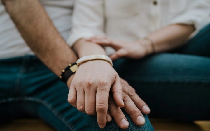 A close-up of a couple holding hands