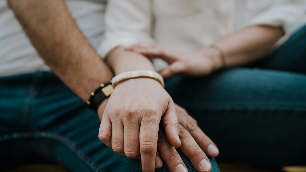 A close-up of a couple holding hands