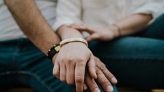 A close-up of a couple holding hands