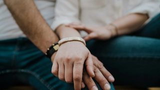 A close-up of a couple holding hands