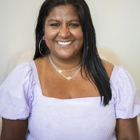 Alma therapist Sweta Venkataramanan smiles in a lilac shirt.