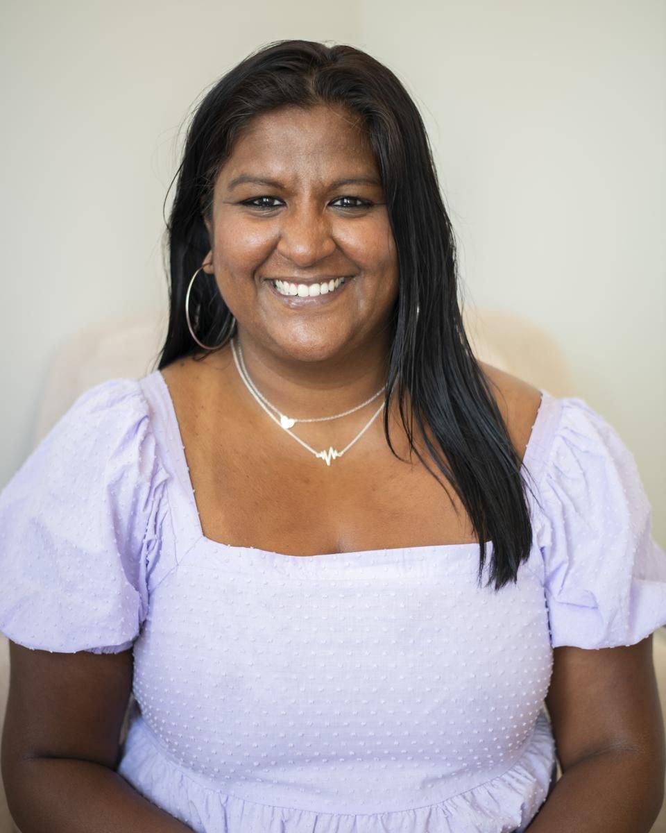 Alma therapist Sweta Venkataramanan smiles in a lilac shirt.
