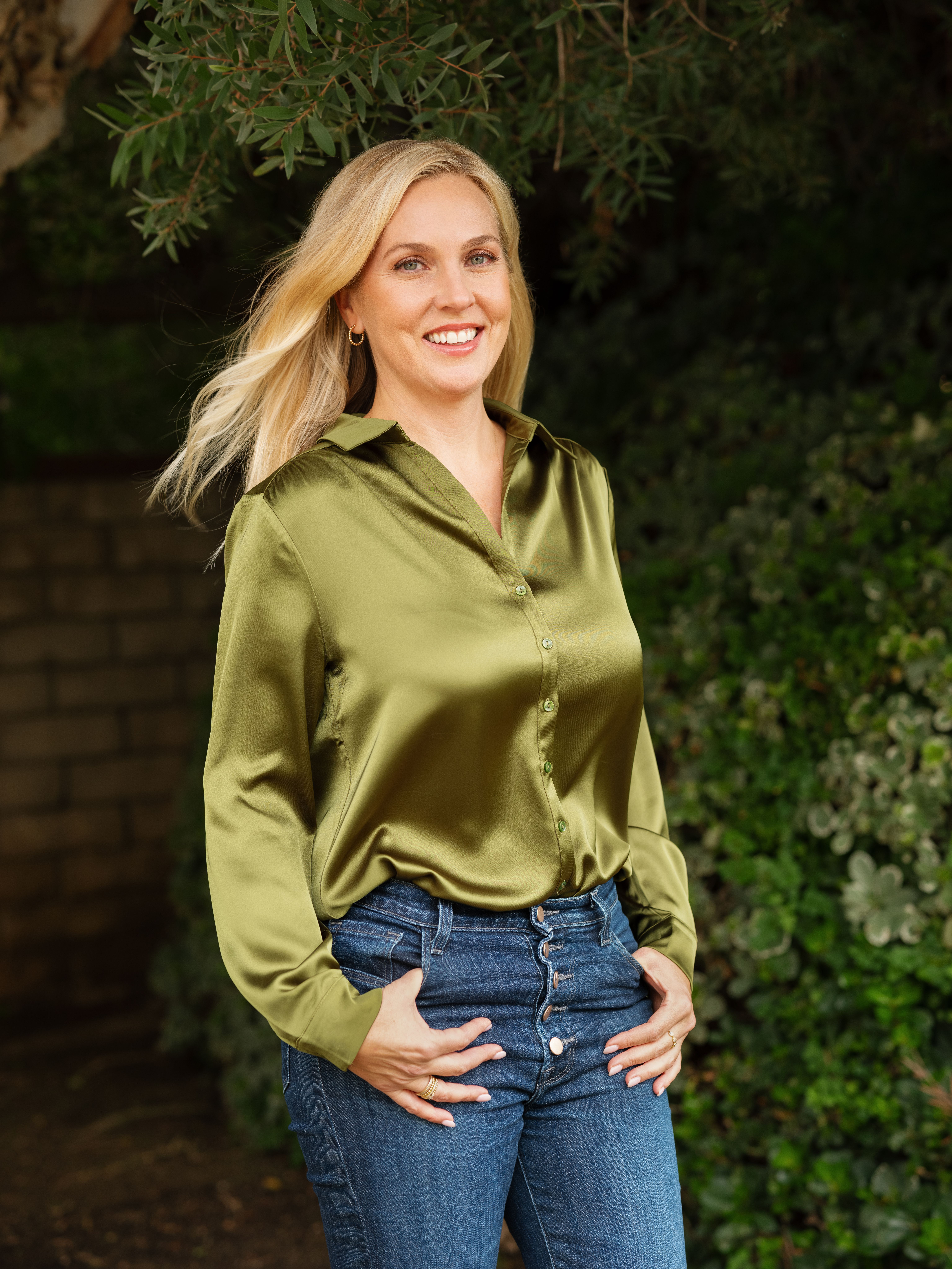 An image of Nicole walking along a green path outside her therapy office.