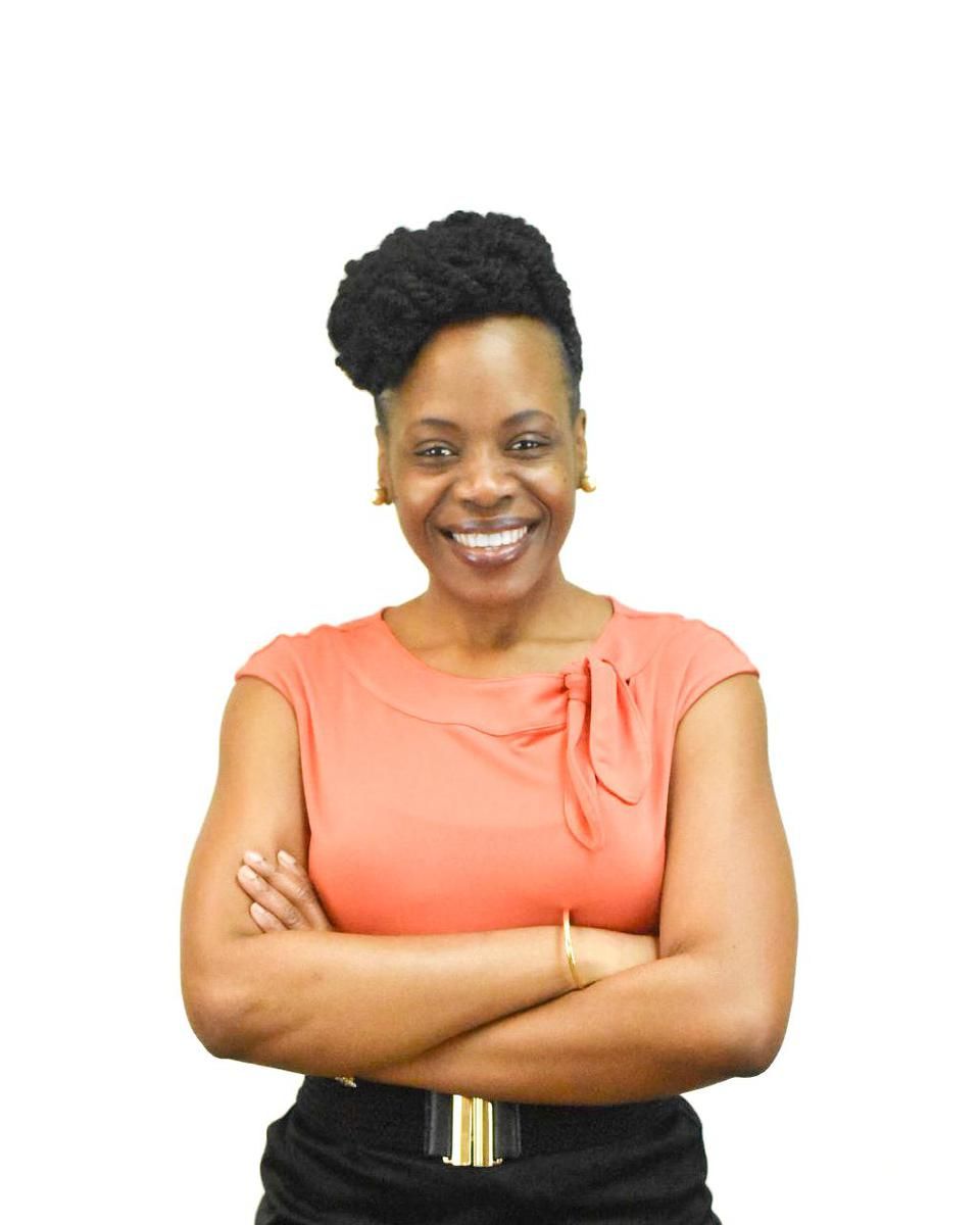 A picture of Antoinette Bryce, arms crossed, against a white backdrop.