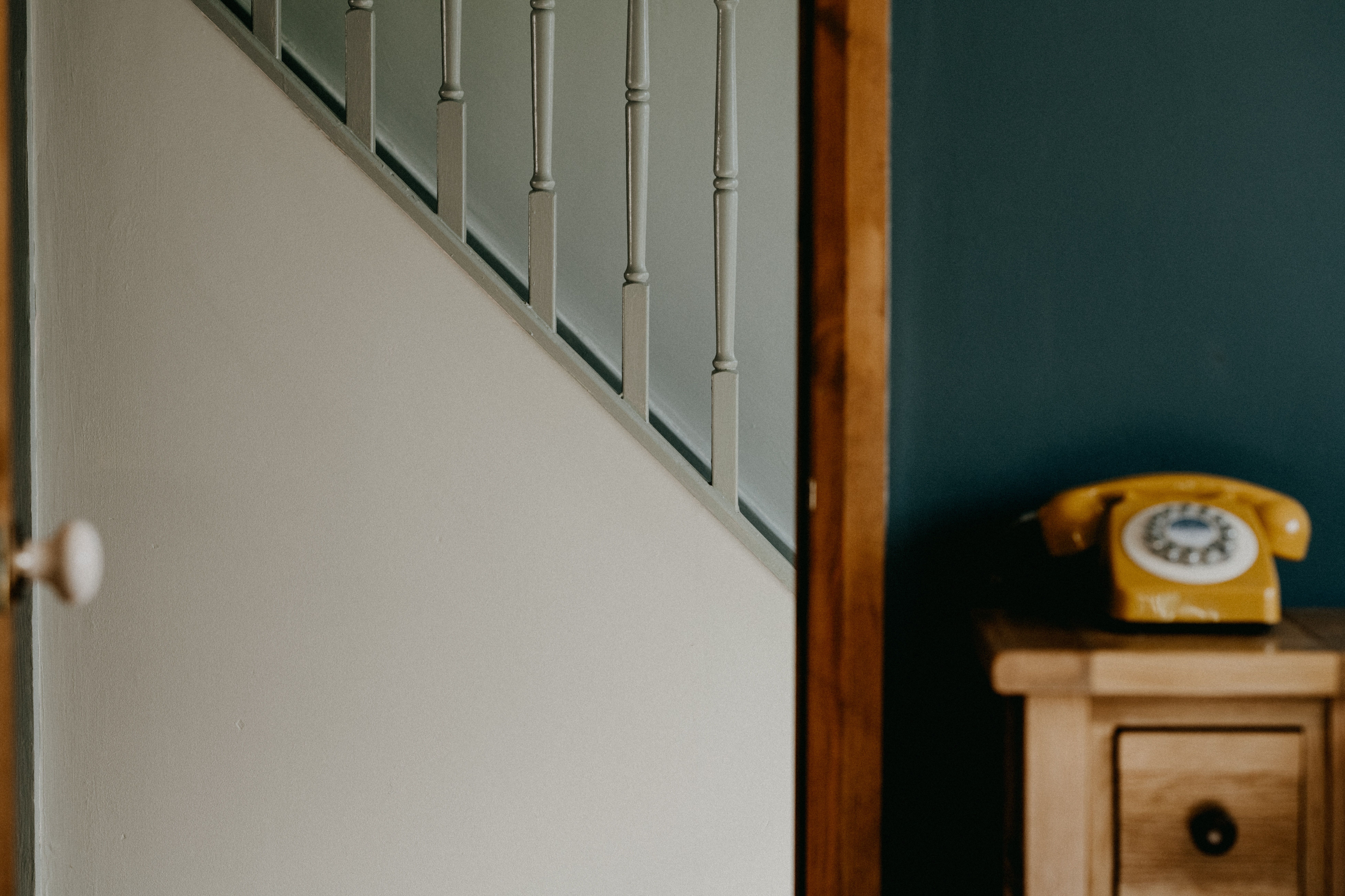 A fleeting glance from within a quiet therapy office, looking through an open door into an empty hallway.