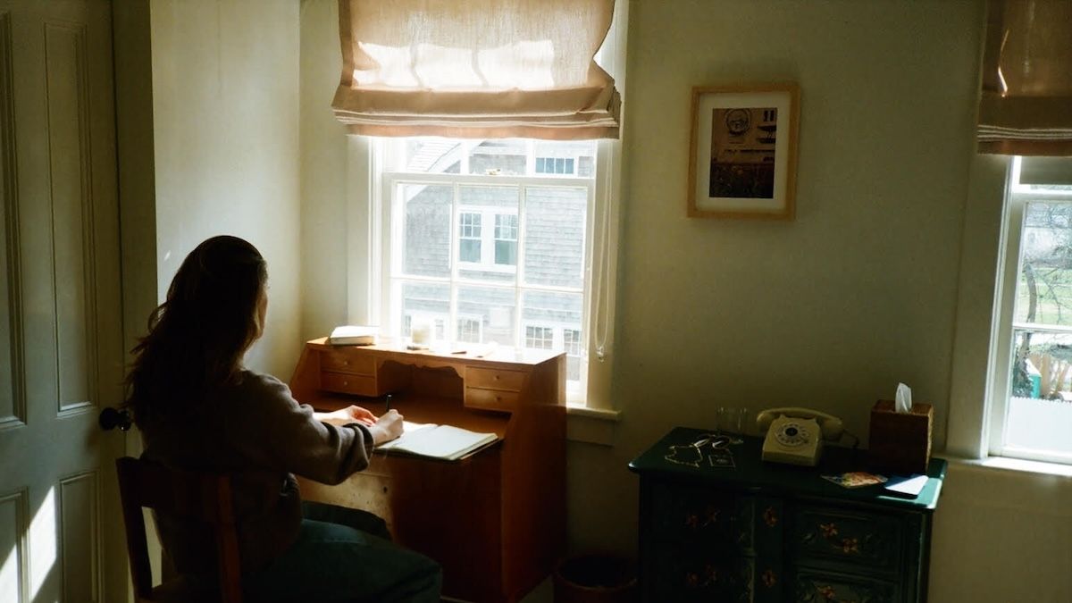 Haley Jakobson looking out the window in her Brooklyn, NY, apartment.