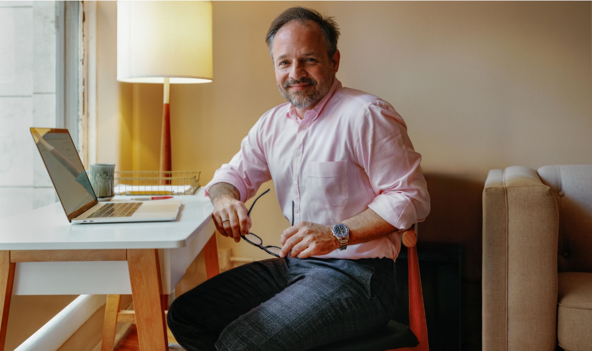 Image of a clinician sitting at a desk with a laptop on it
