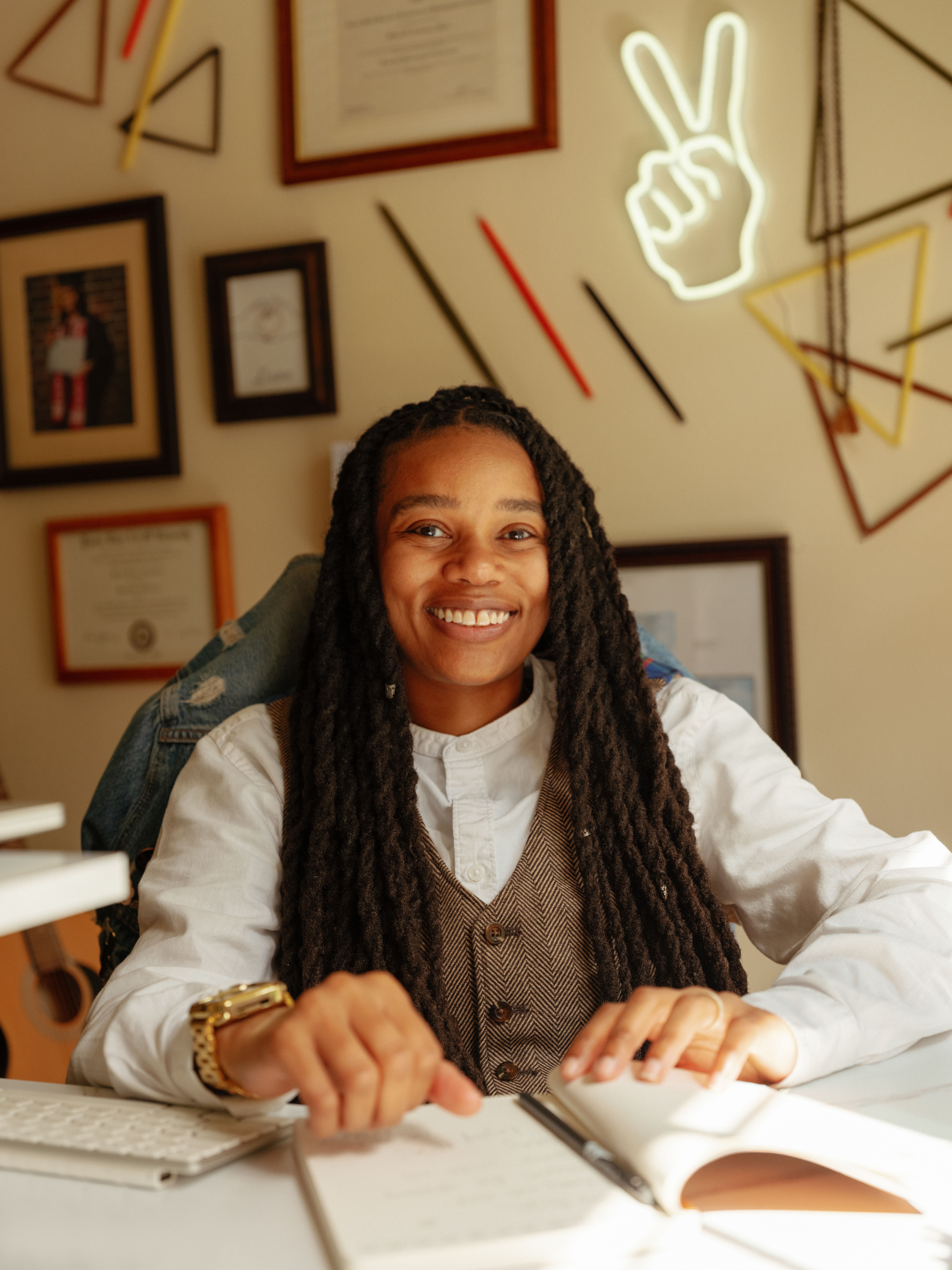 A smiling Britni sitting in their fun and hip therapy office.
