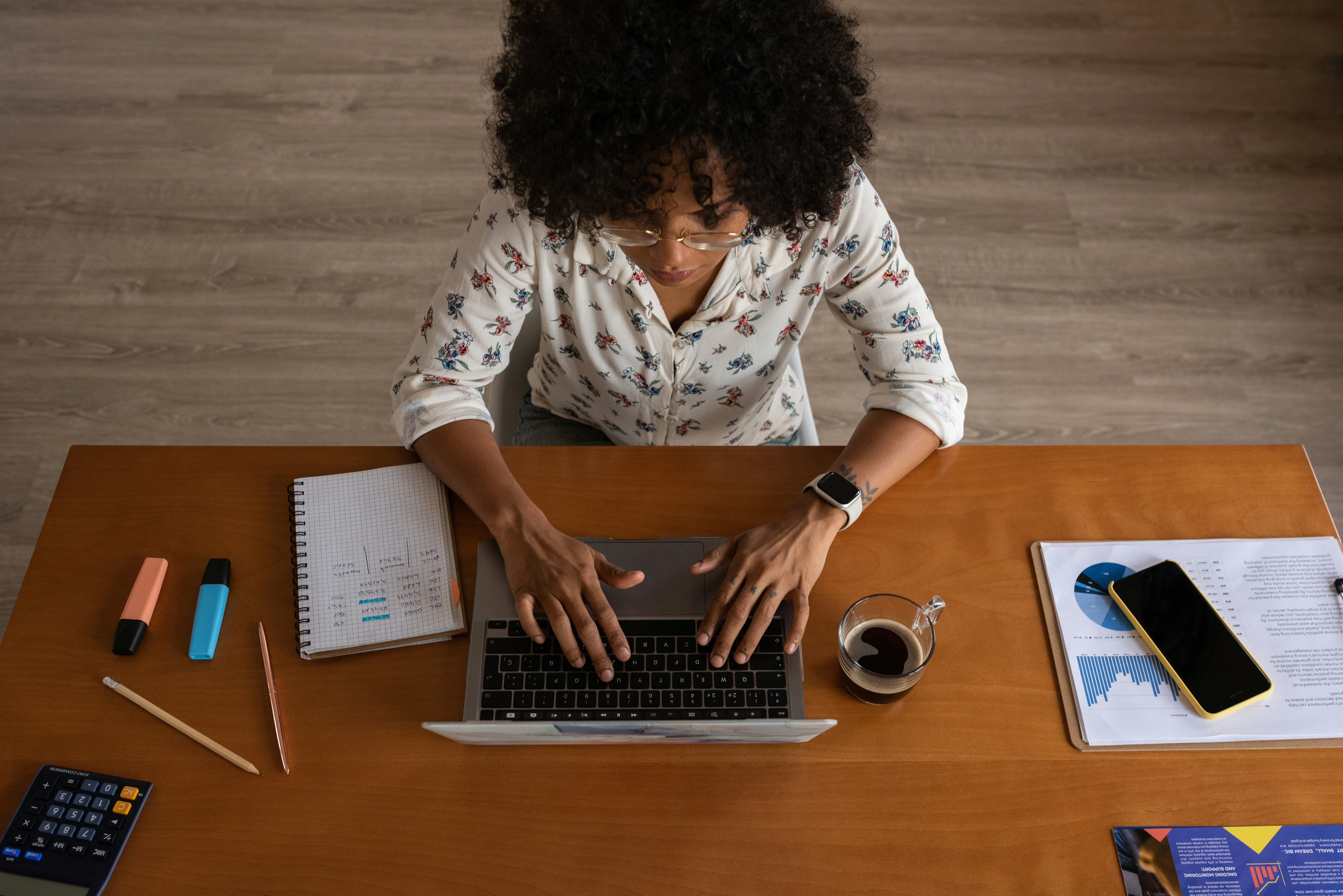 Woman working on her laptop in her office