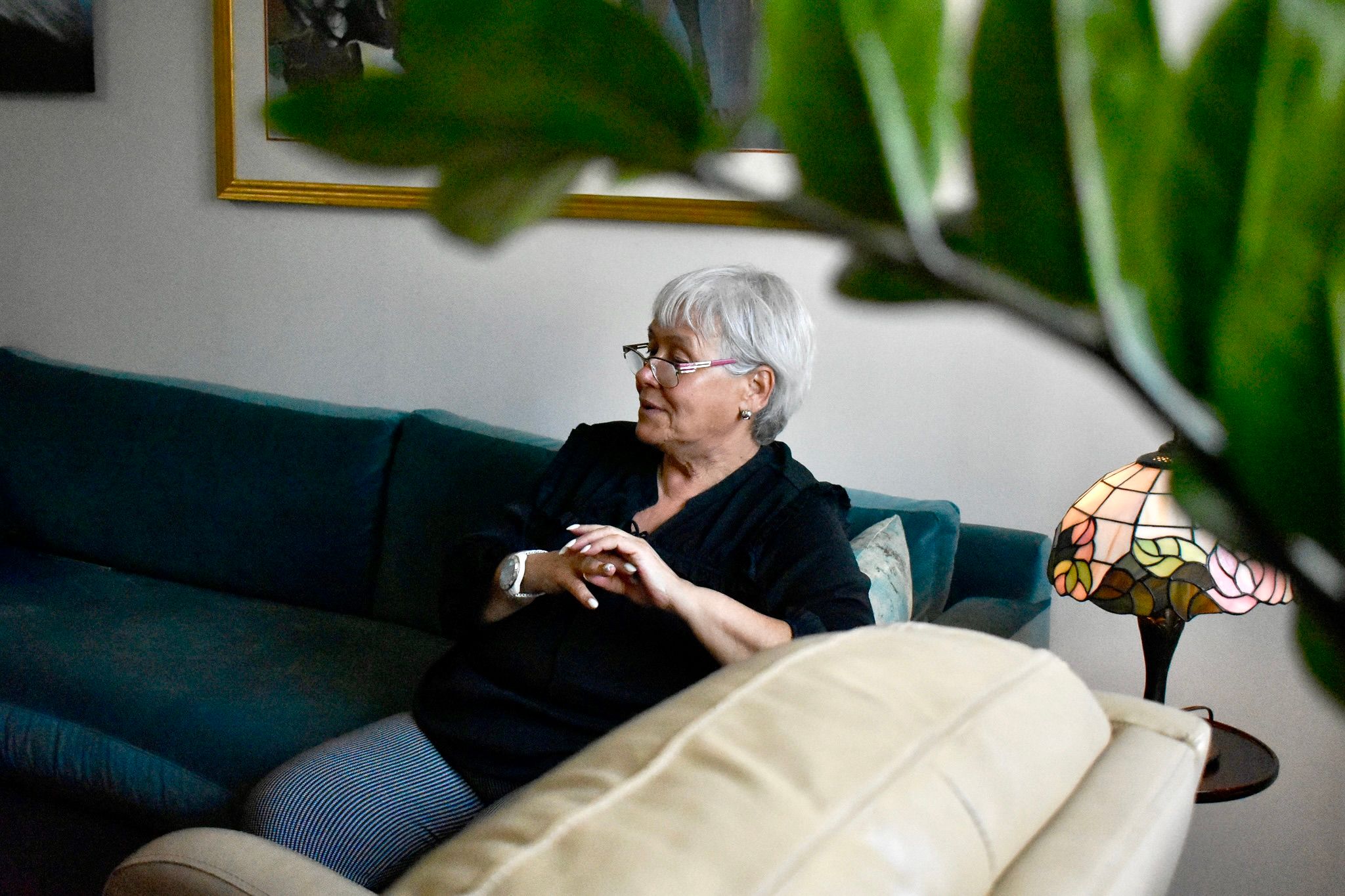 A behind-the-scenes image of a therapist featured in Alma's new campaign, resting on a couch in her office.