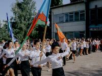 From the series "Left Bank". Students of the school N9 carry the state and regional flags during the Last Bell manifestation. Ribnita, Transnistrian Region, Republic of Moldova. | DER GREIF