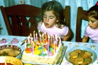 Maria Mavropoulou, "A girl 5 years old blowing the candles of her birthday cake at a home", Athens, Greece, 2023 | DER GREIF