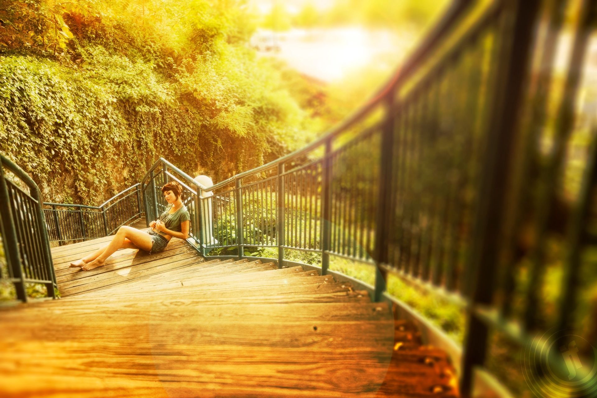 Chloe reclined on wooden river stairs in golden afternoon light, ivy wall behind