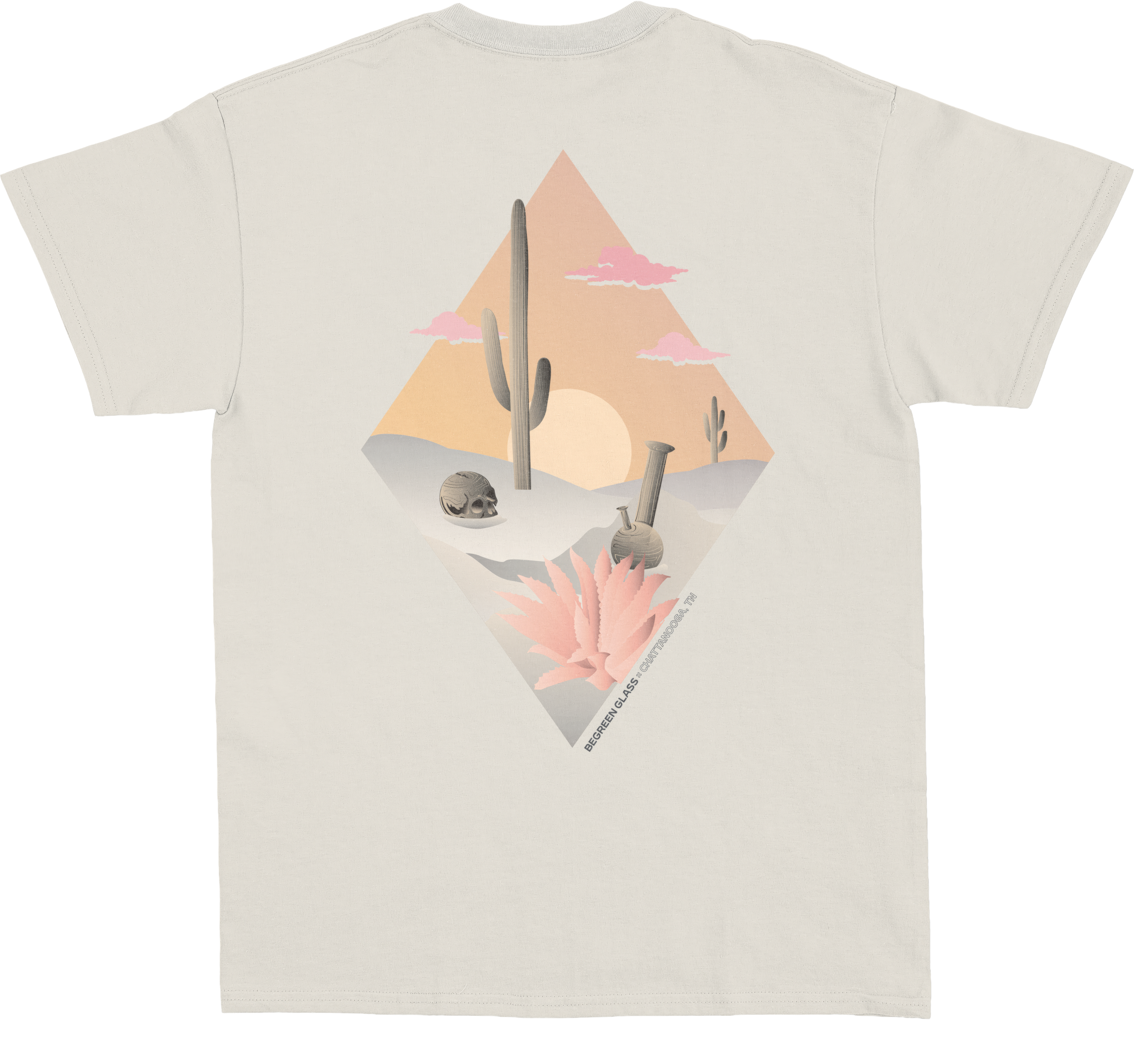 The BeGreen Glass desert diamond printed on the back of a sand-coloured tee — cactus, skull and water pipe in a sunset diamond.