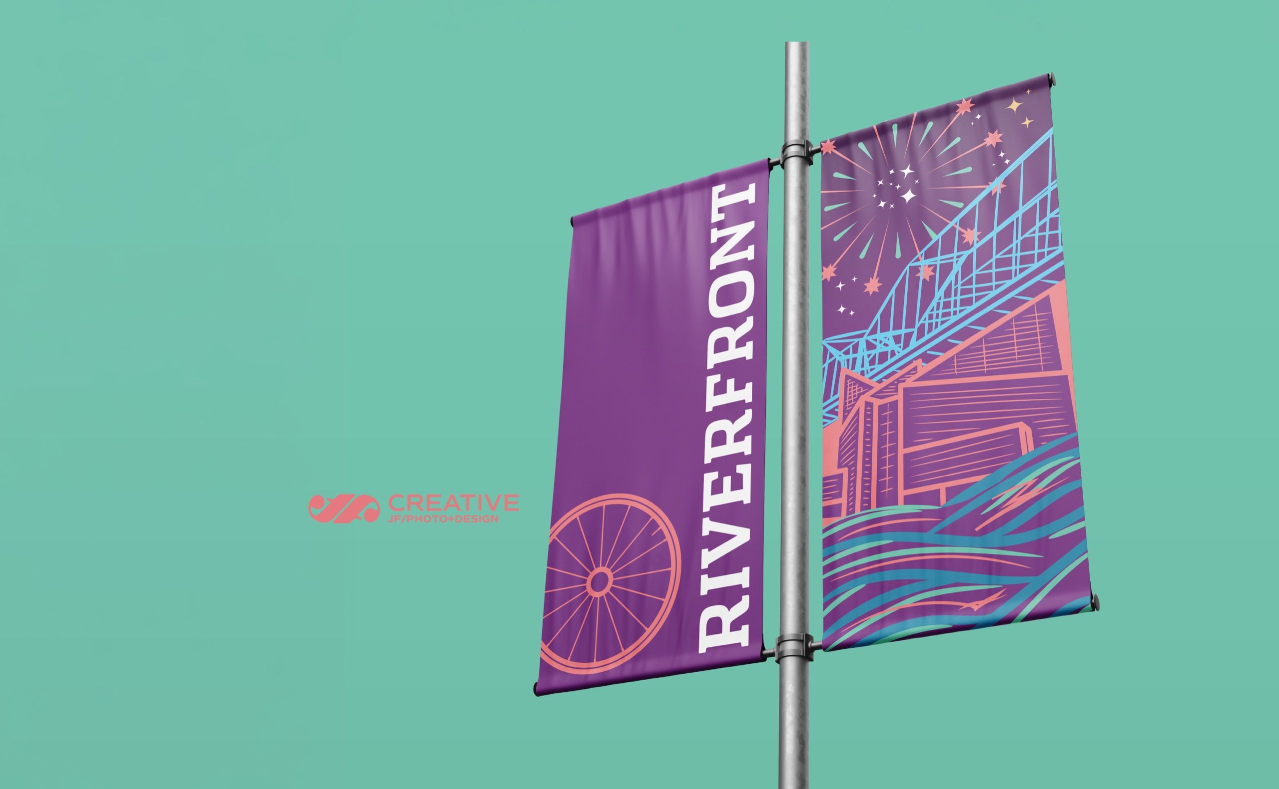 Riverfront banner pair mounted on a lamppost against a teal ground