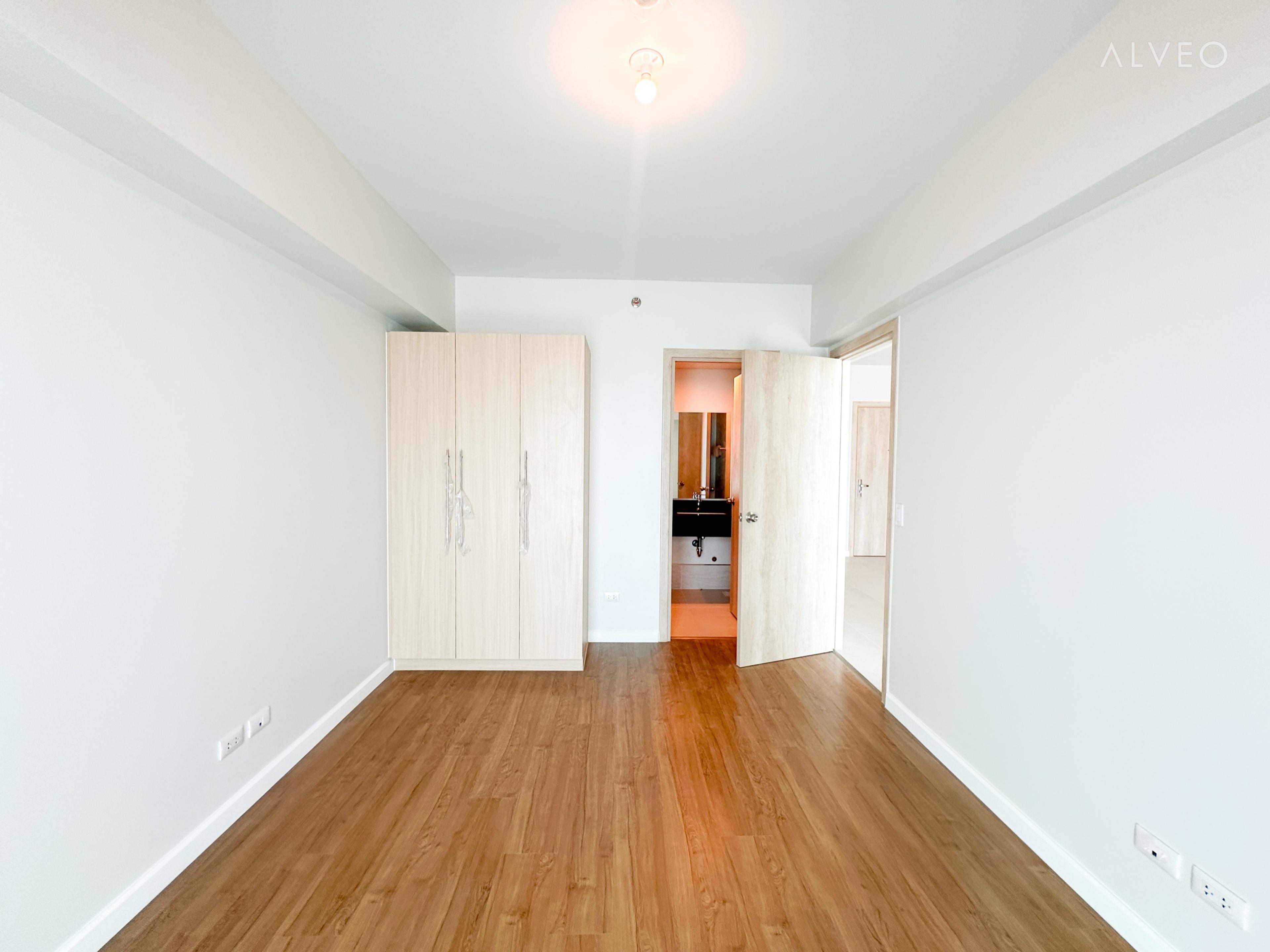 Cerule at Solinea two-bedroom unit bedroom at turnover, with a built-in wardrobe and an ensuite bathroom doorway