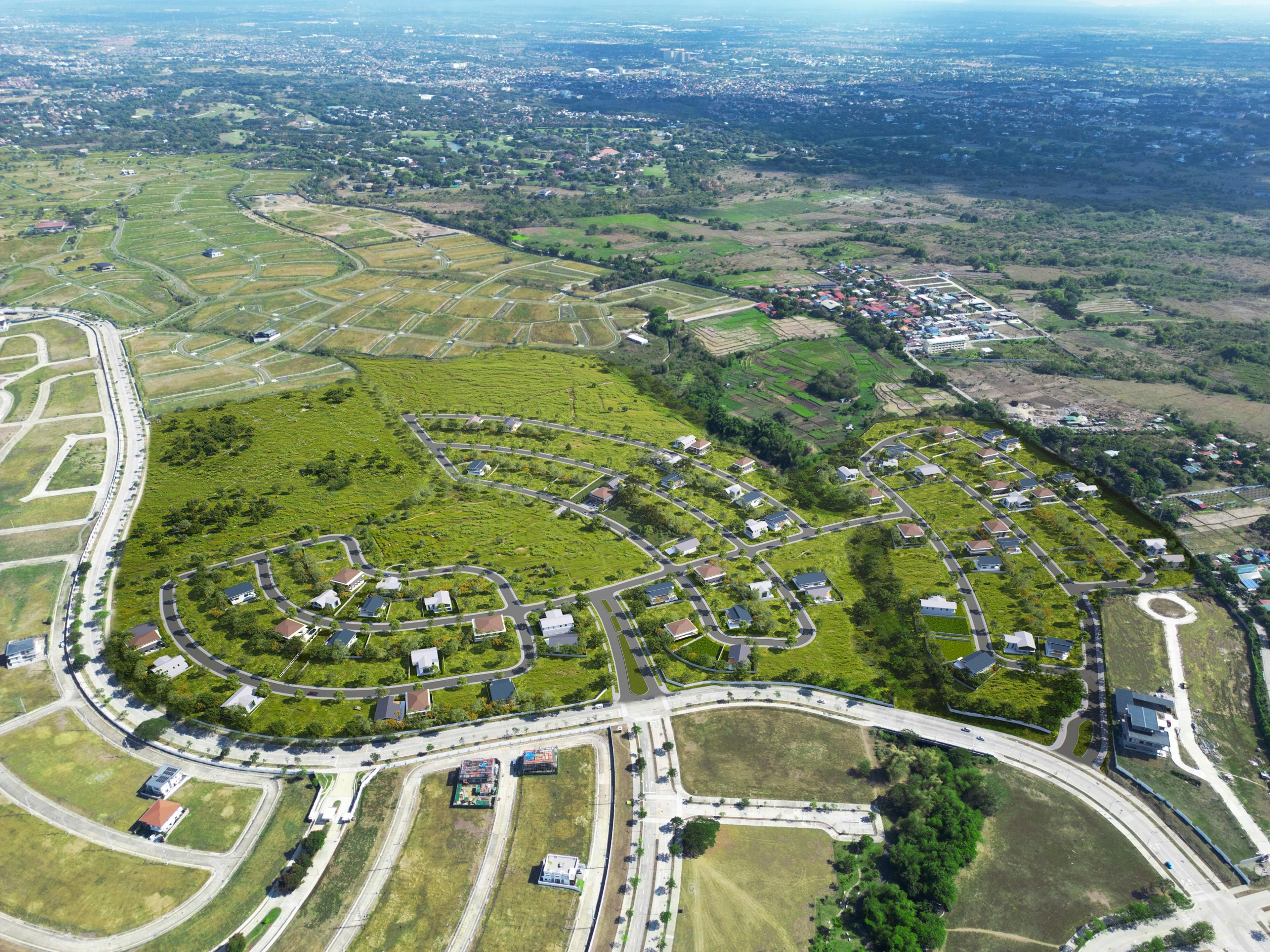 Aerial view of Crescent Grove village in Vermosa, Cavite, showing the curving road network, landscaped lots and clubhouse area
