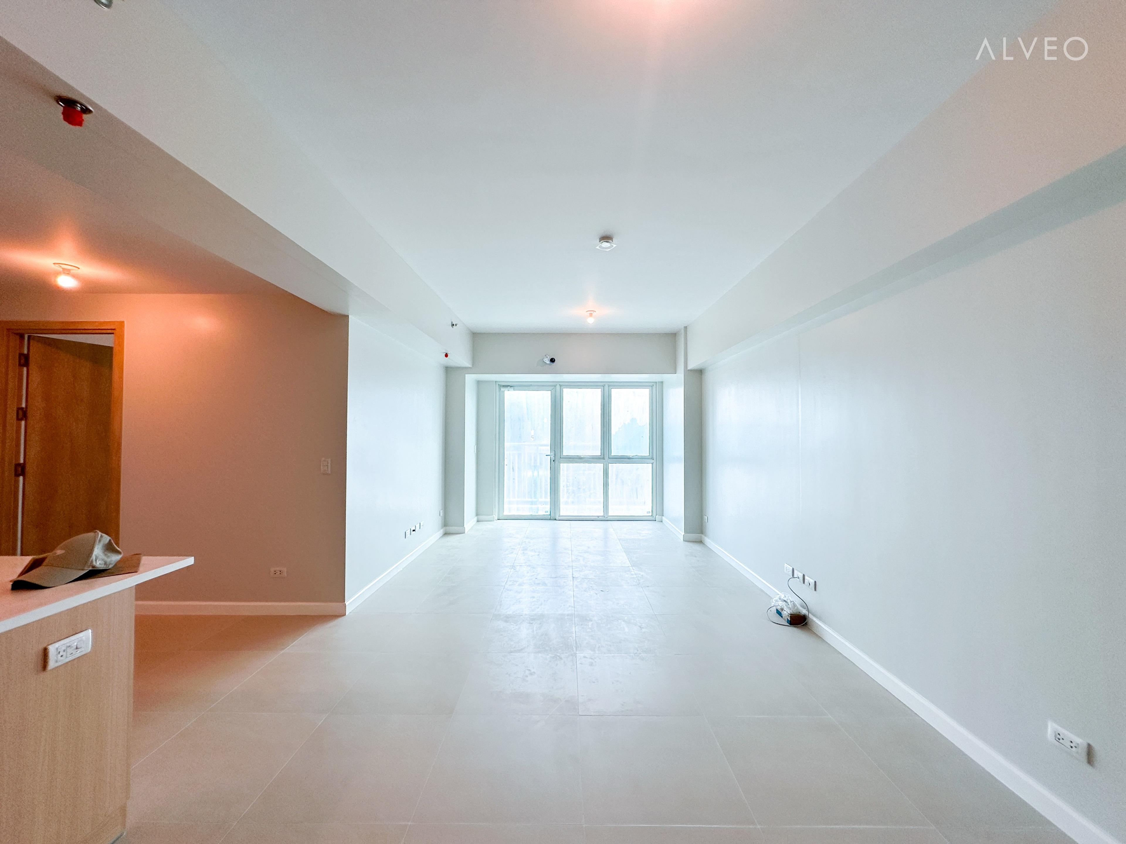 Cerule at Solinea three-bedroom unit open living and dining area at turnover, with tiled floor and a wide window letting in daylight