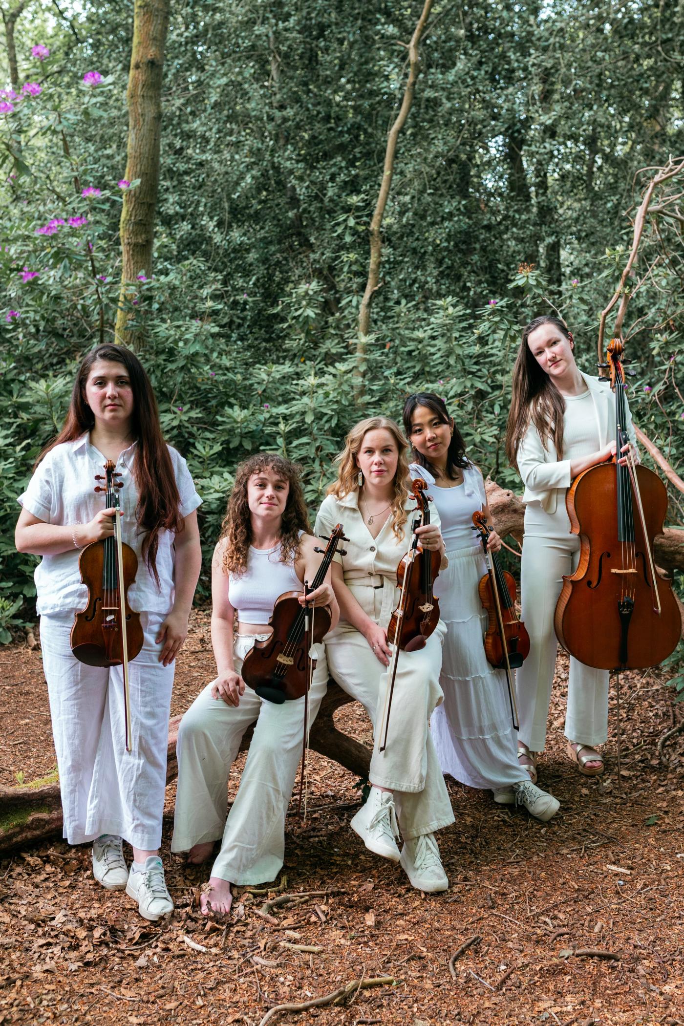 Sekine about - sekine quartet holding their instruments in a woodland