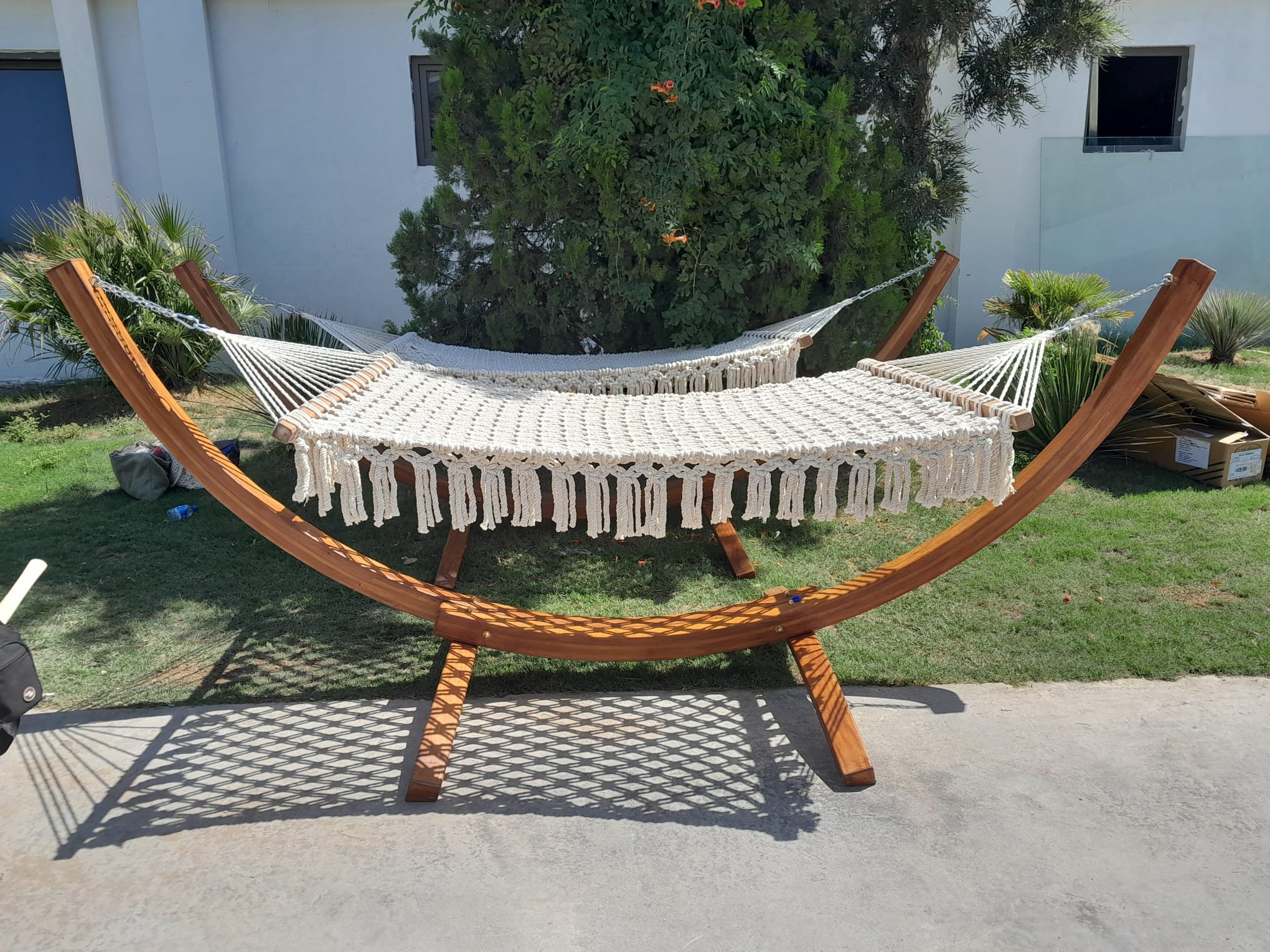 Dimare handwoven macramé hammock with fringe on a curved timber stand at Ethno Hotels Belek