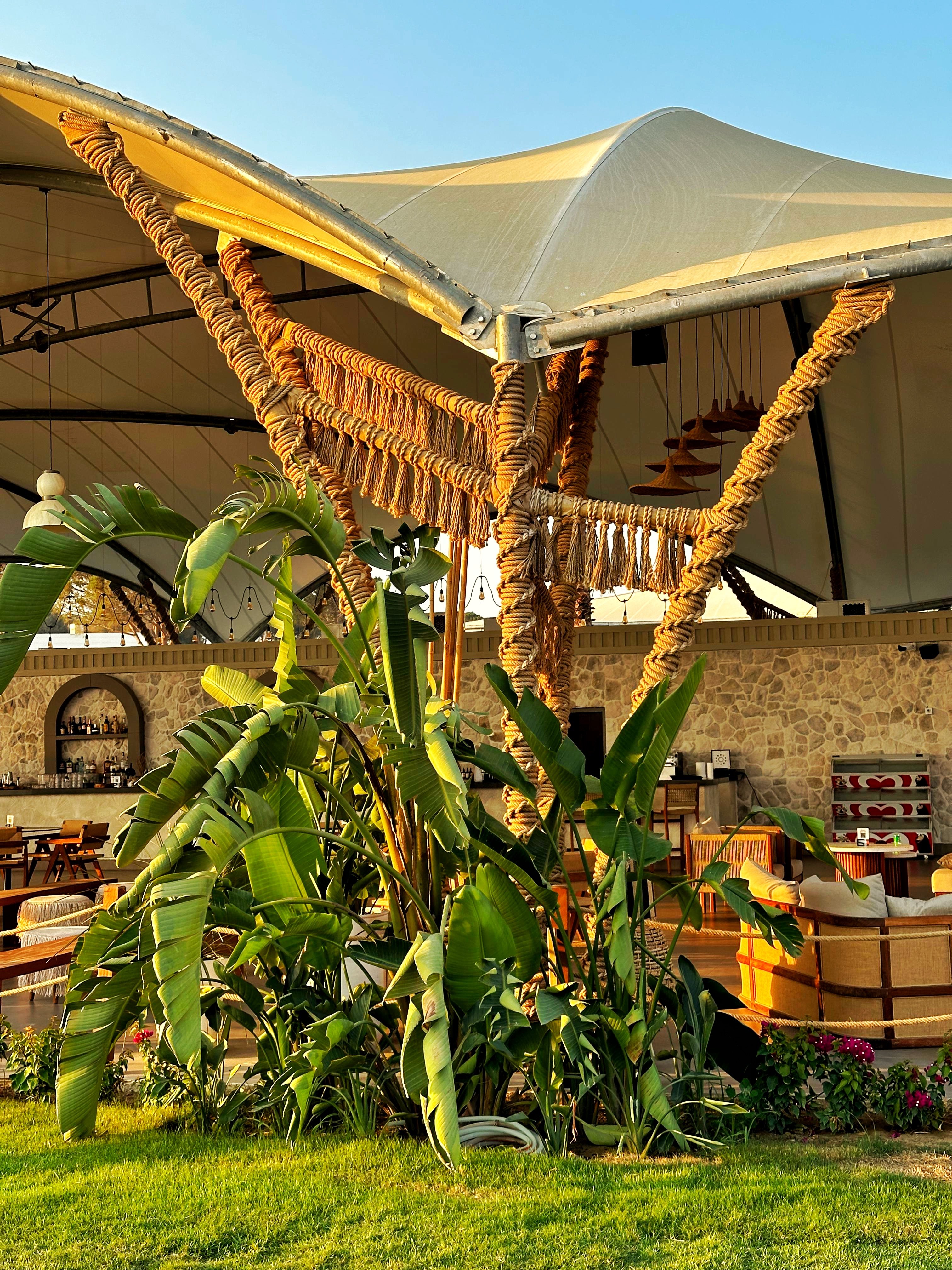 Rope-wrapped uprights and hanging fringe beneath the pavilion roof at Ethno Hotels Belek