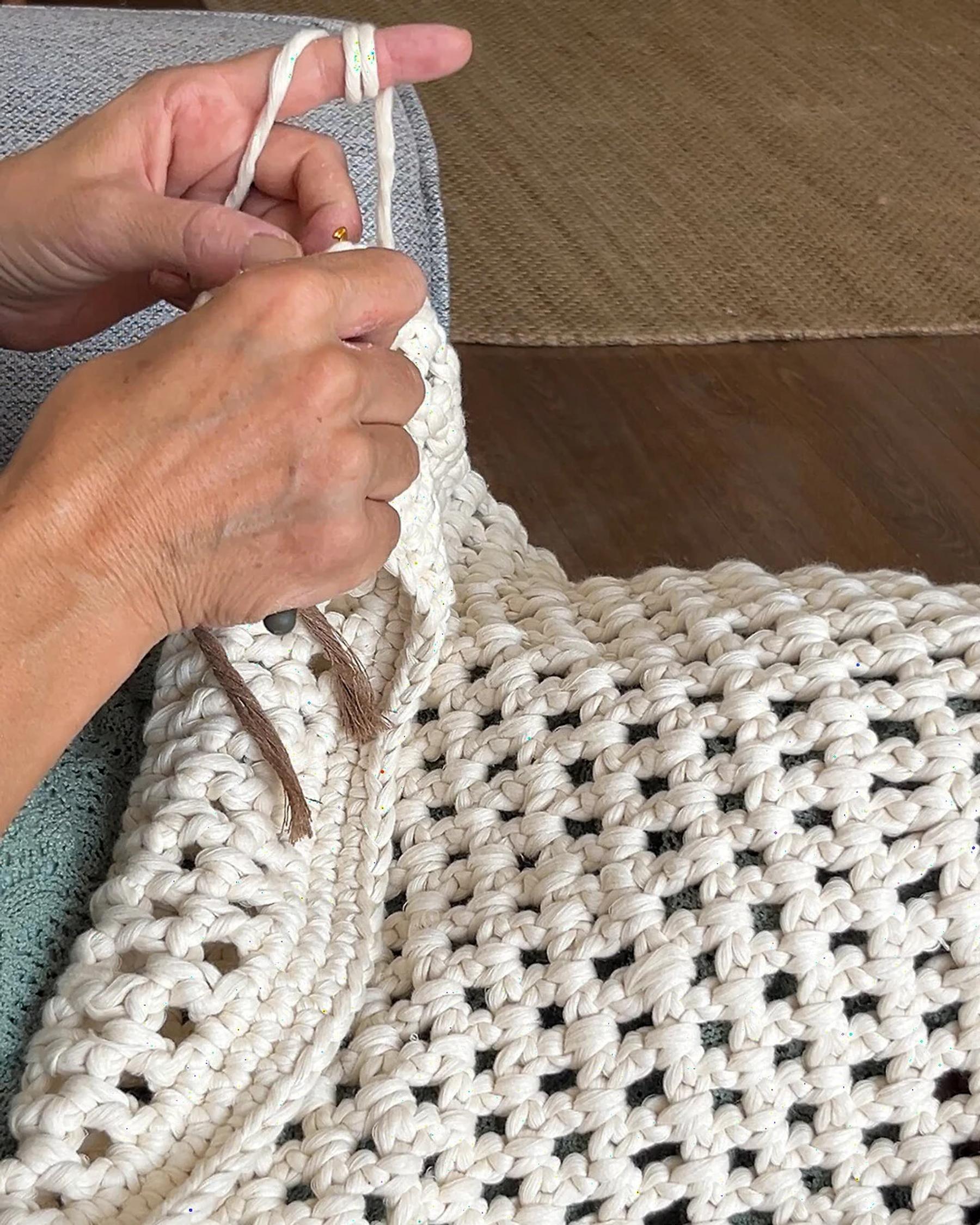 Hand knotting the ecru parasol surface
