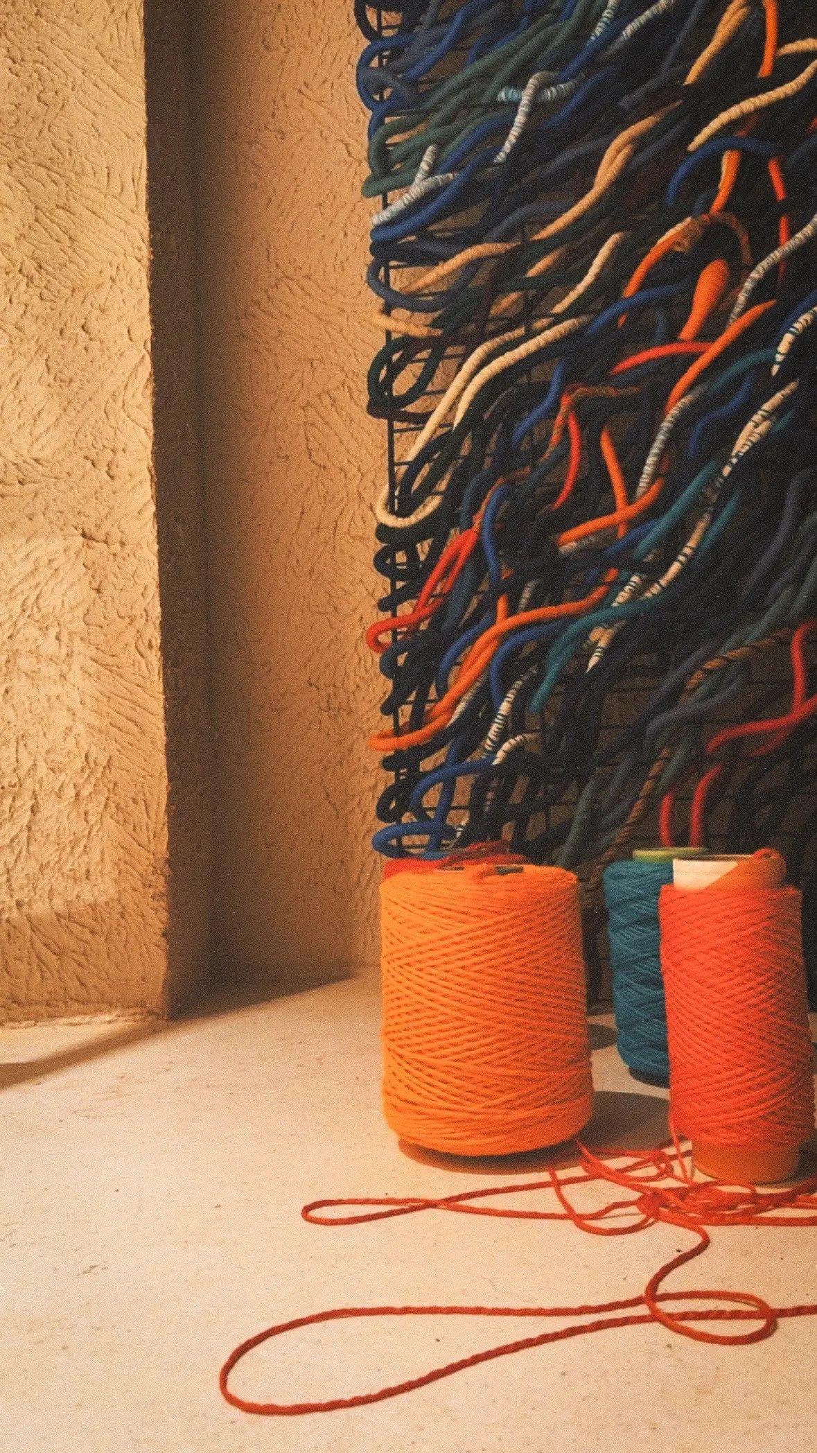 Detail of Mavi with spools of orange and blue rope