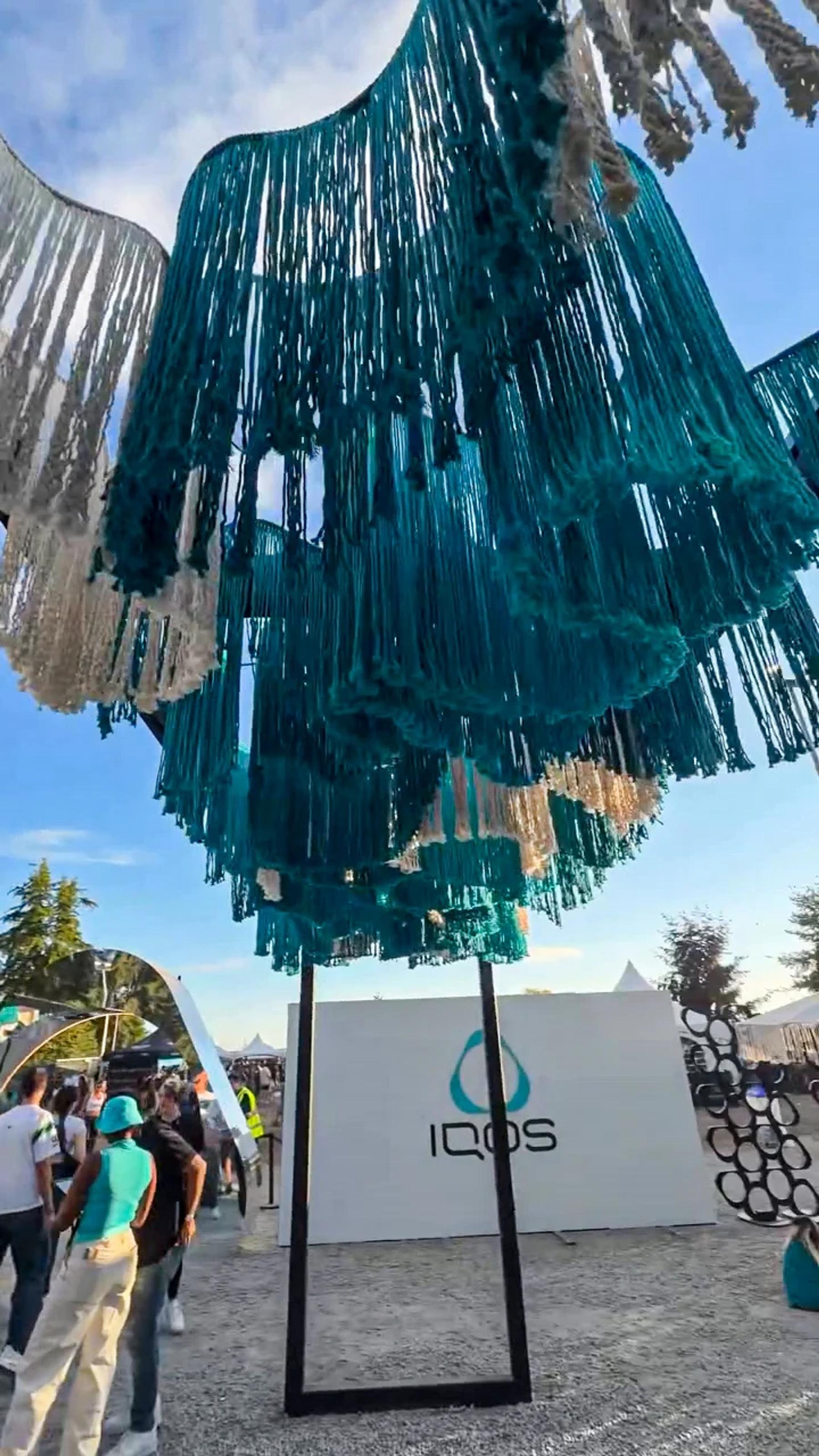 Turquoise fringe and the IQOS activation backdrop