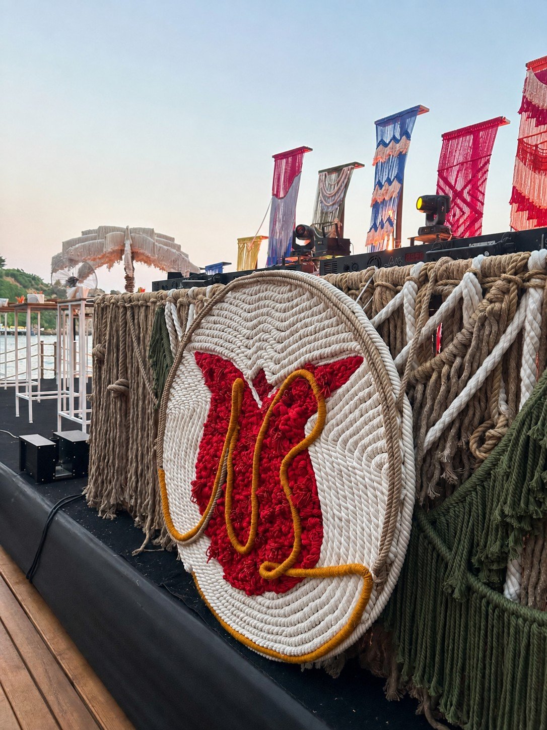 Dimare hand-knotted rope monogram medallion mounted on the macramé-dressed railing at Bilem Beach