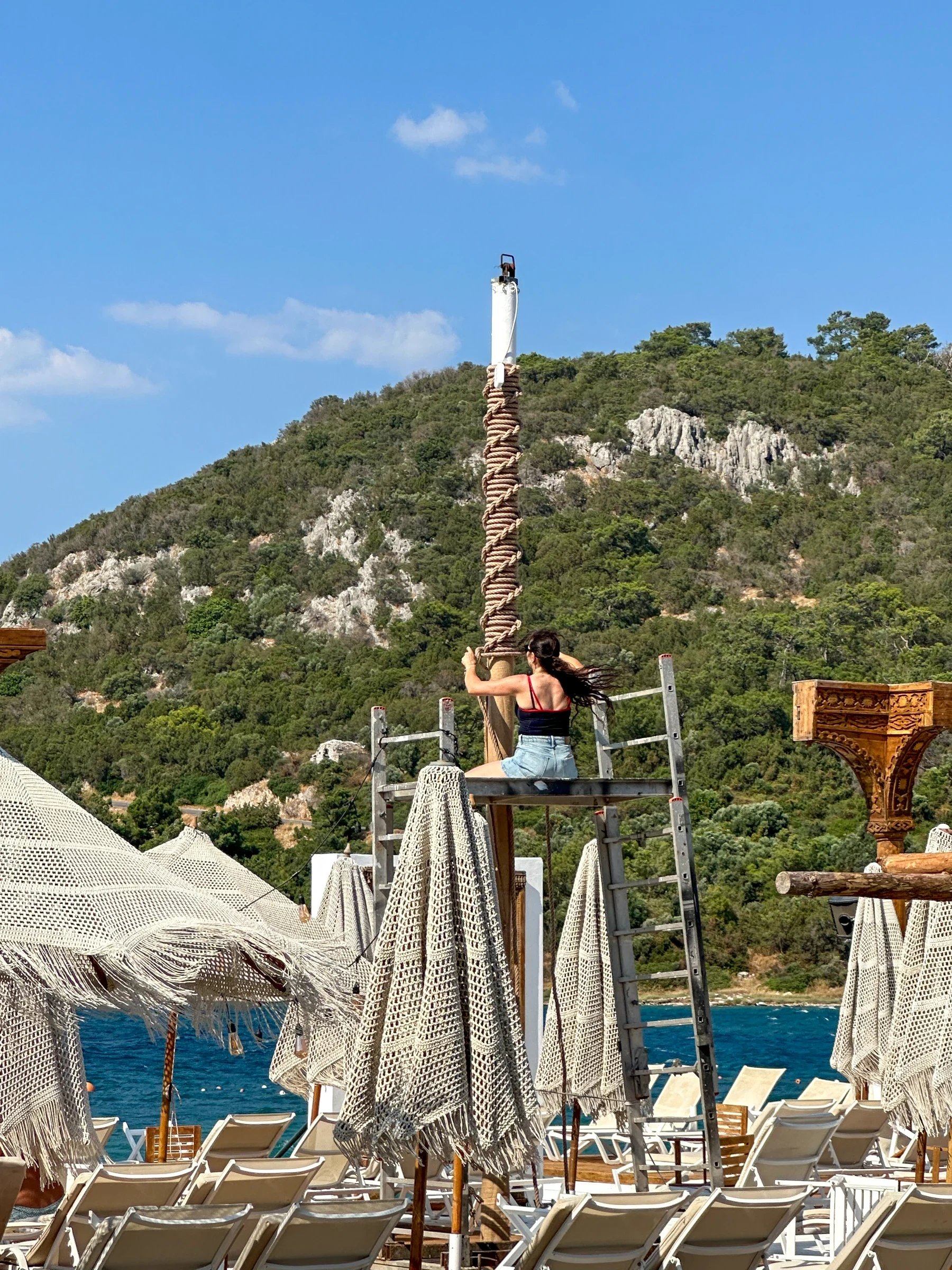 The braided rope trunk of the Dimare Palm Tree being worked on site from a scaffold tower at Reana Beach