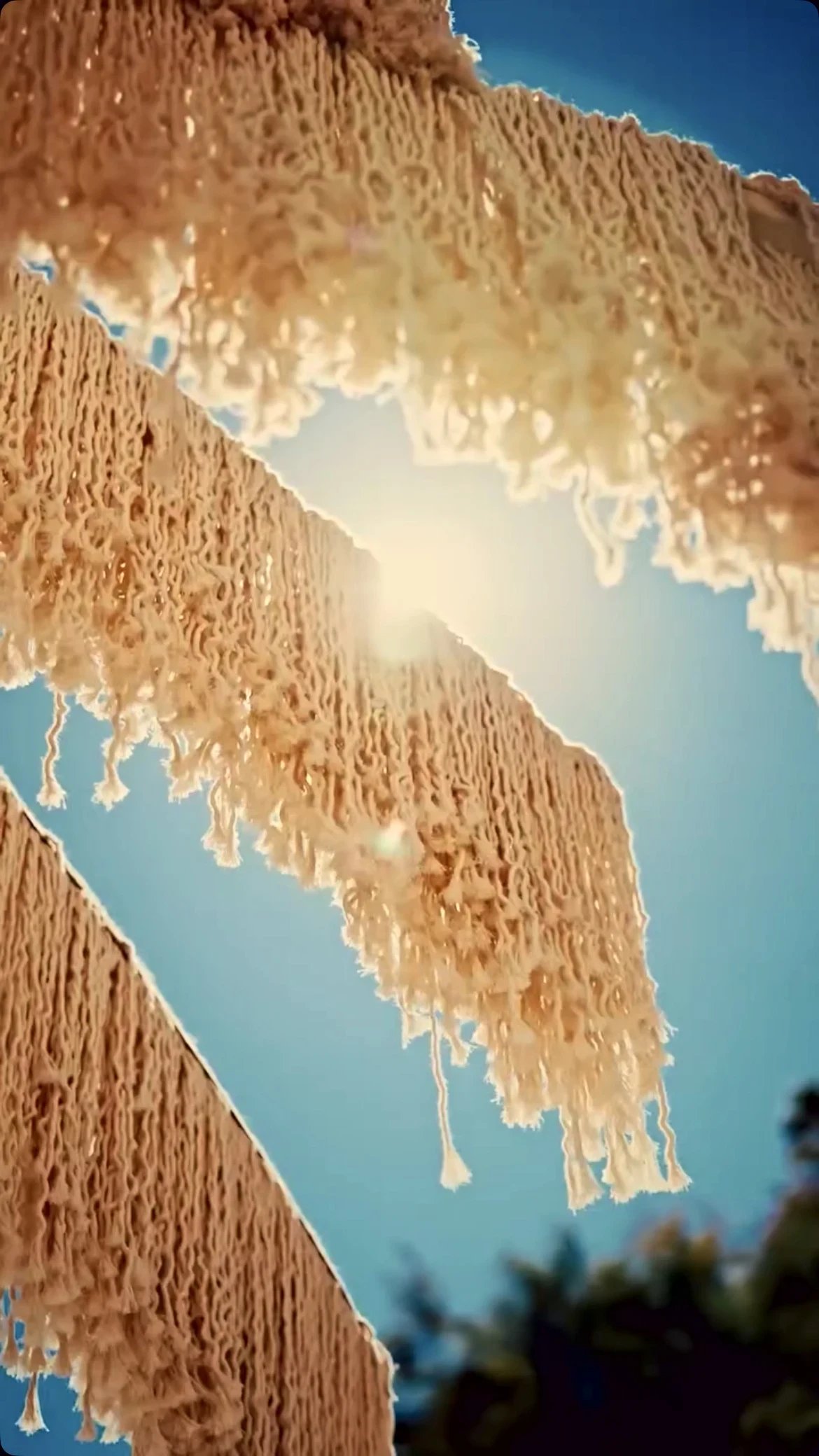 Sunlight through the cream macramé fringe of a Dimare canopy at Bilem Beach