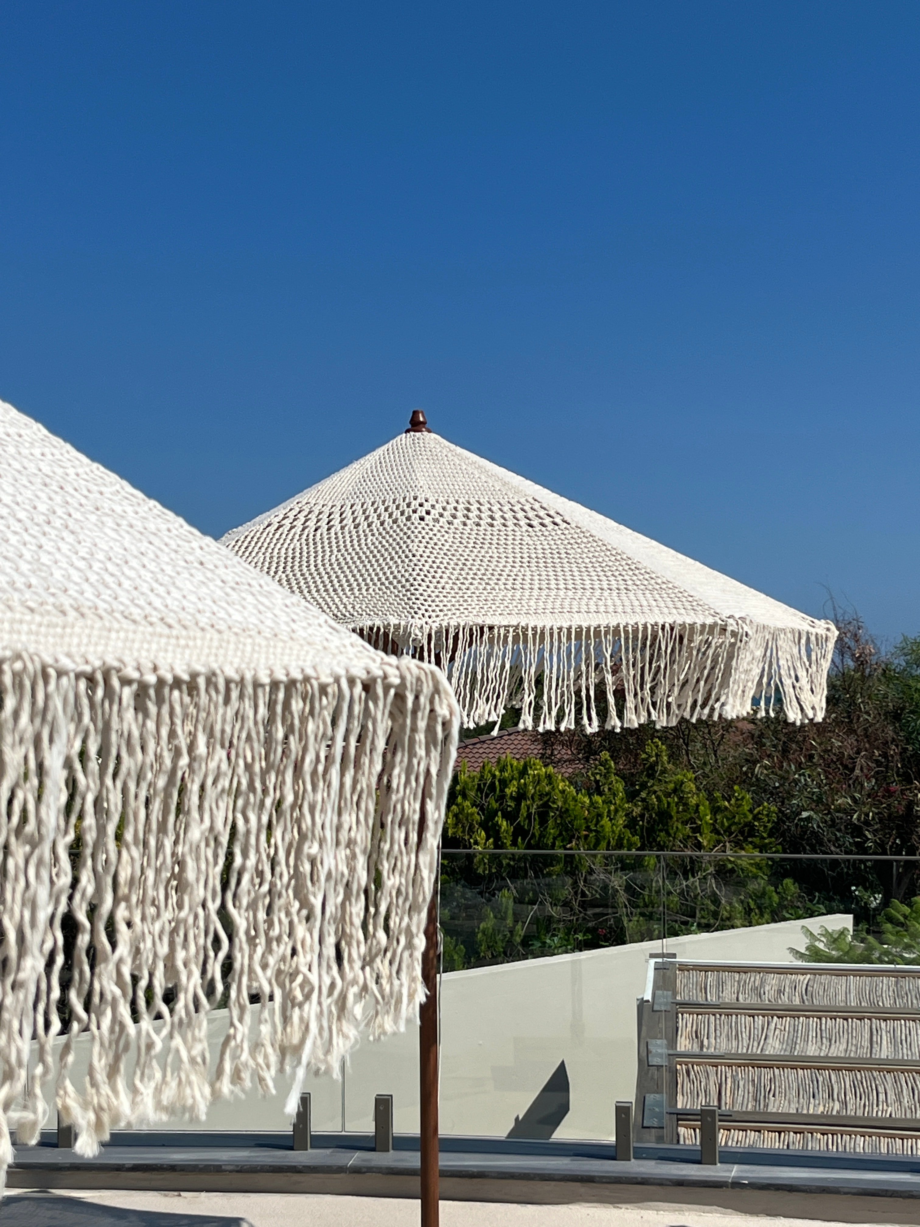 Open crochet canopy and knotted fringe of the macramé parasol