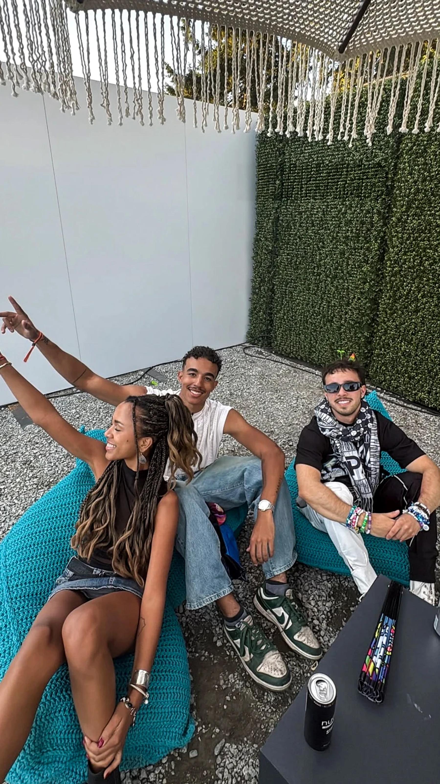 Visitors in the shaded seating area