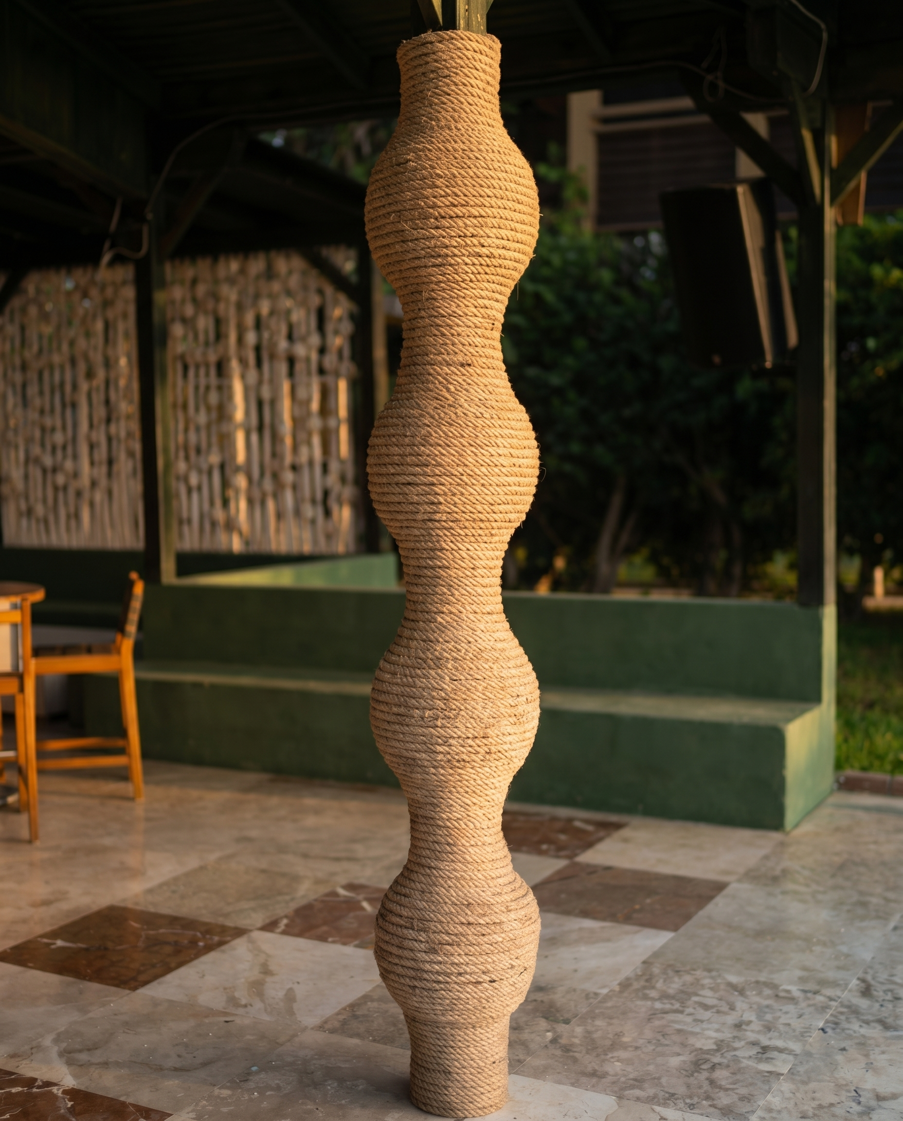 A tall rope-covered sculptural column with alternating rounded and narrow sections at MC Arancia Resort Hotel.