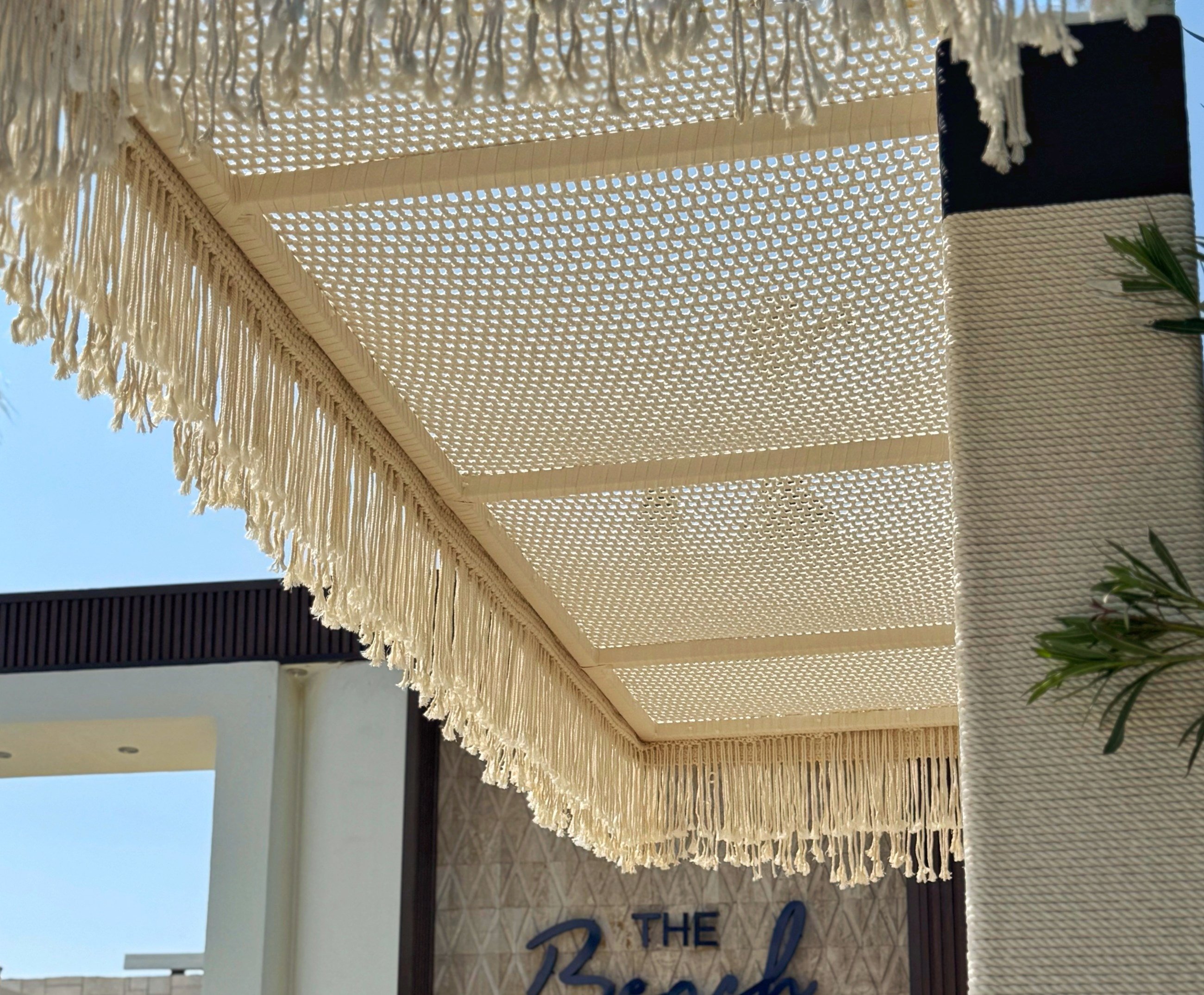 Macramé ceiling panel system set into a timber grid